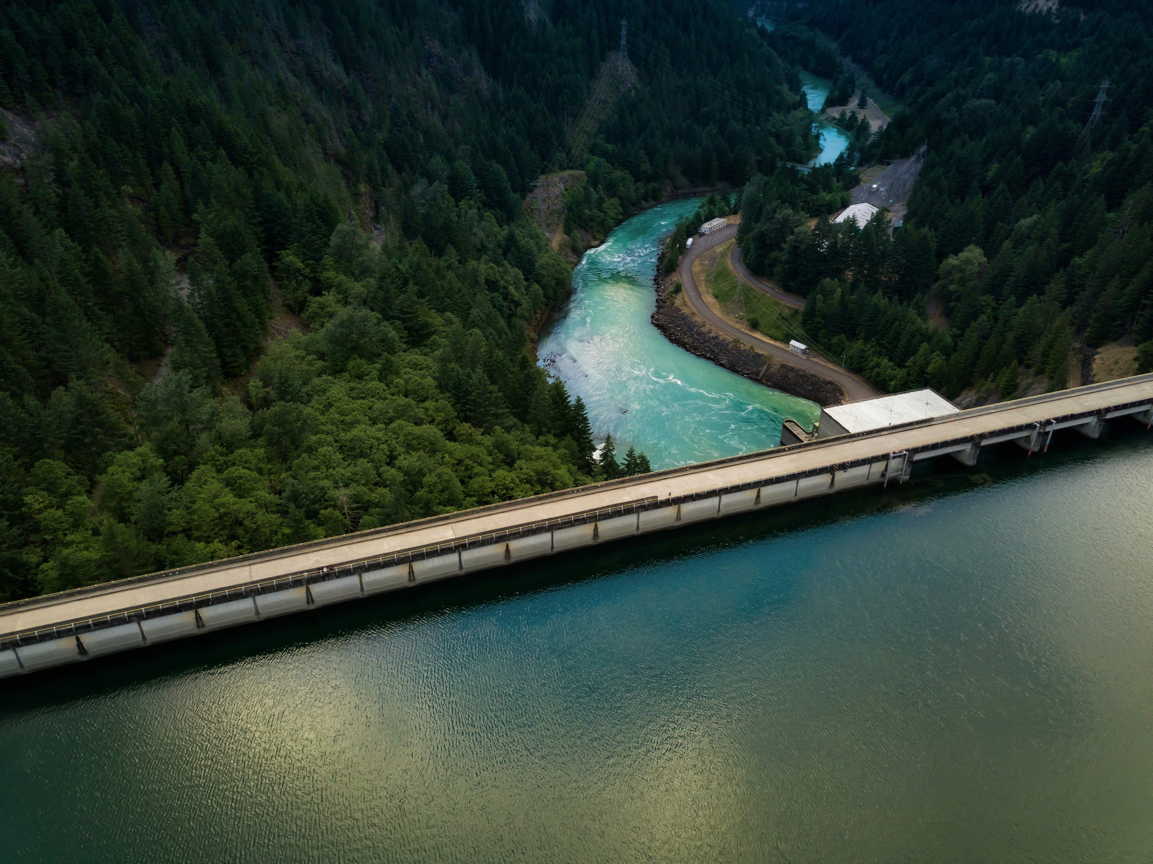 A scenic dam looking over a rushing river.