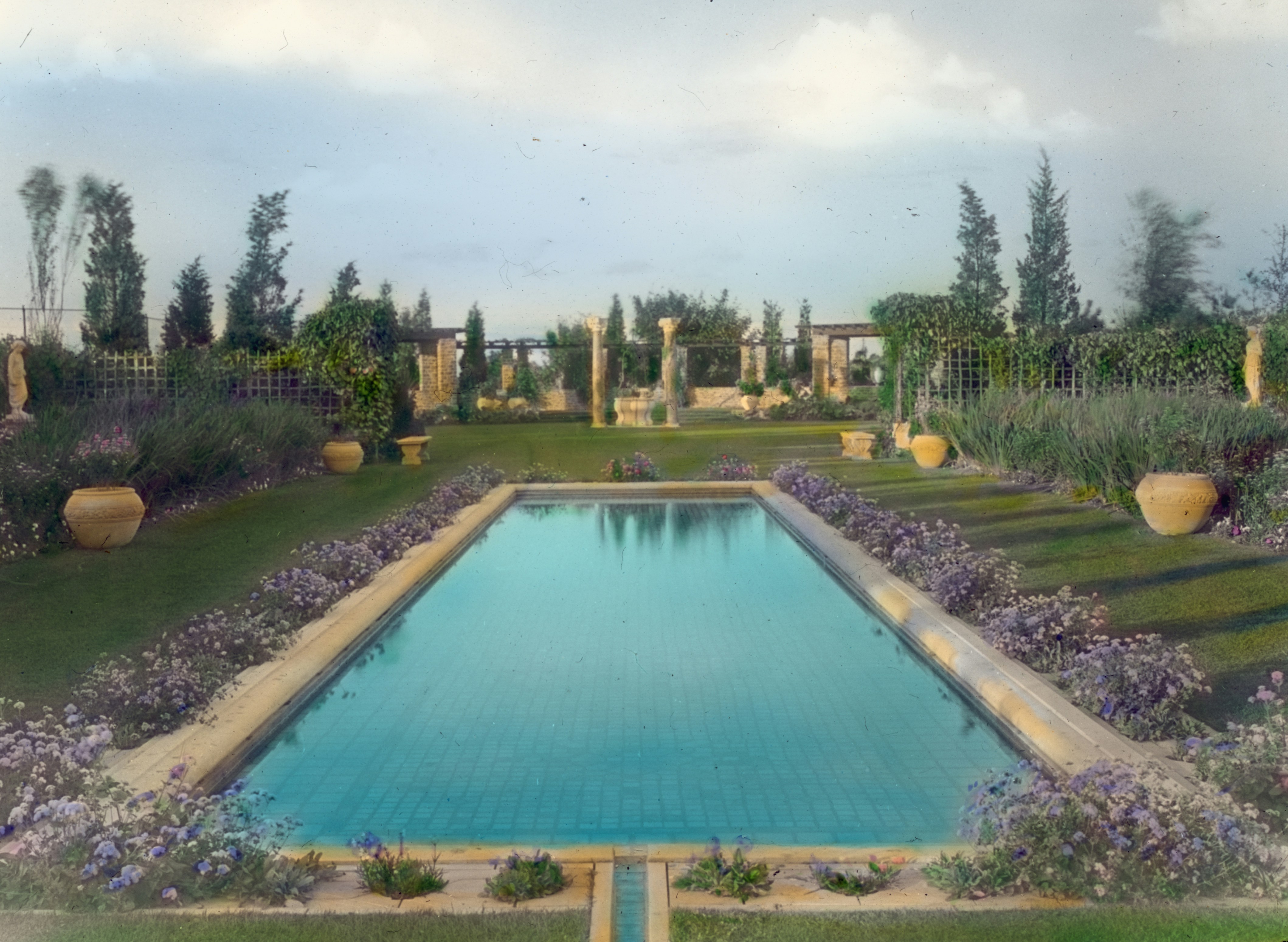 Pool surrounded by lavender and gardens.