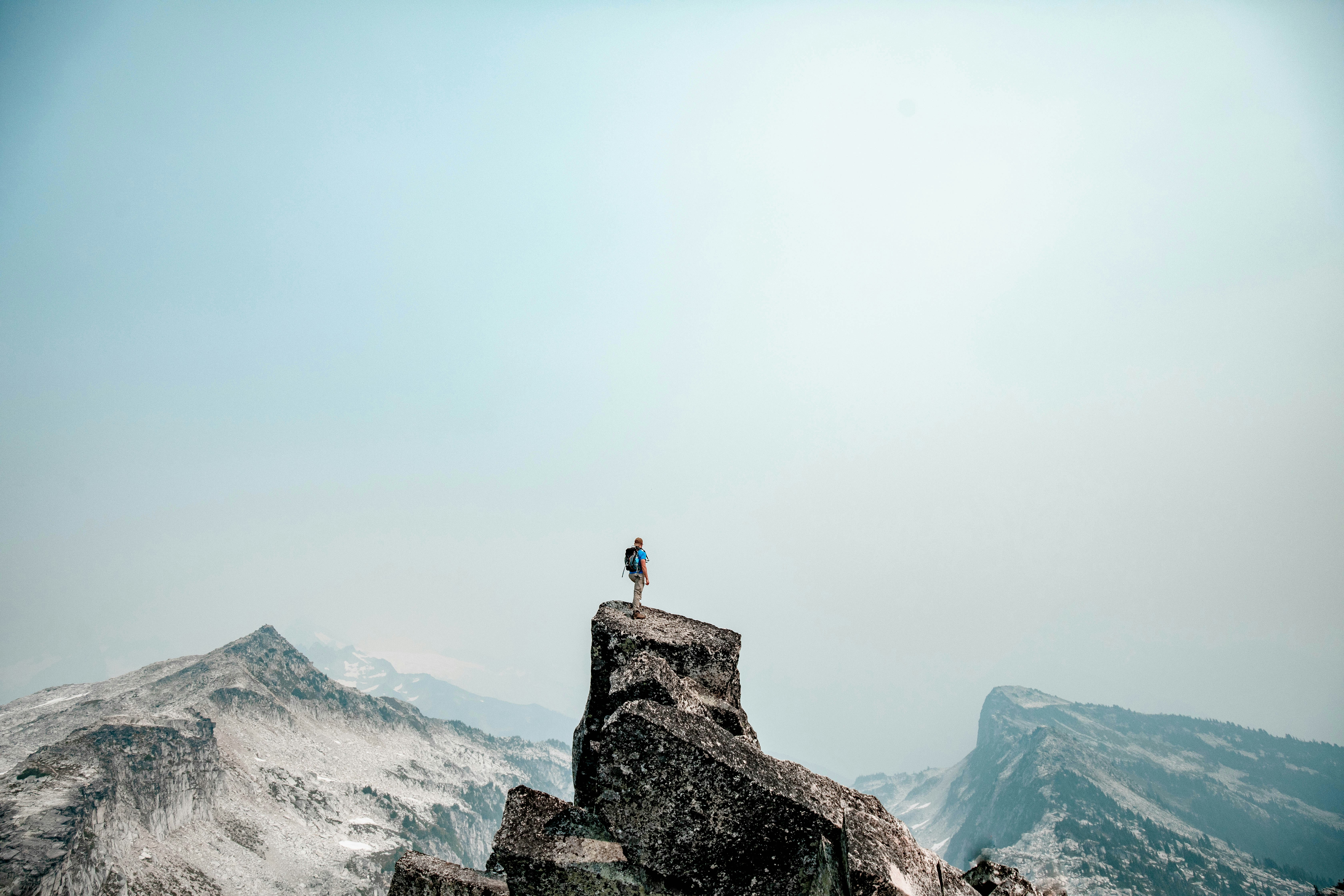 Man reaching the top of a mountain