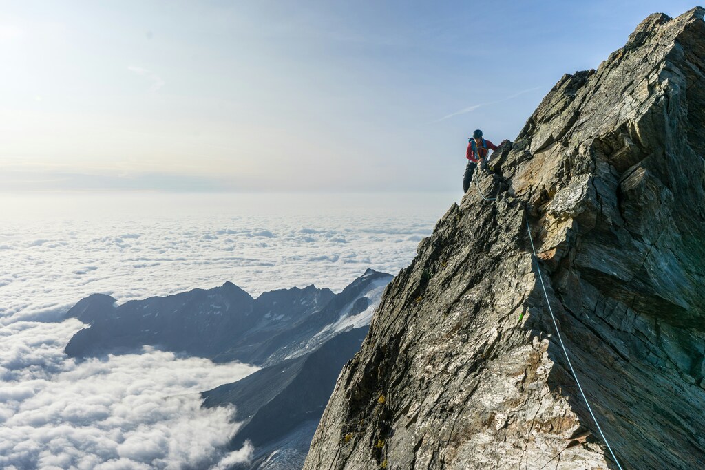 Man admiring the top of a mountain peak hike