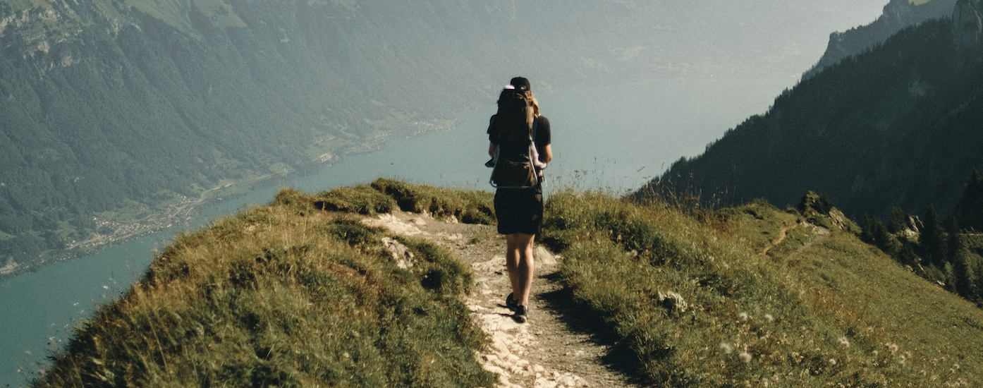 Man running on mountain hike peak