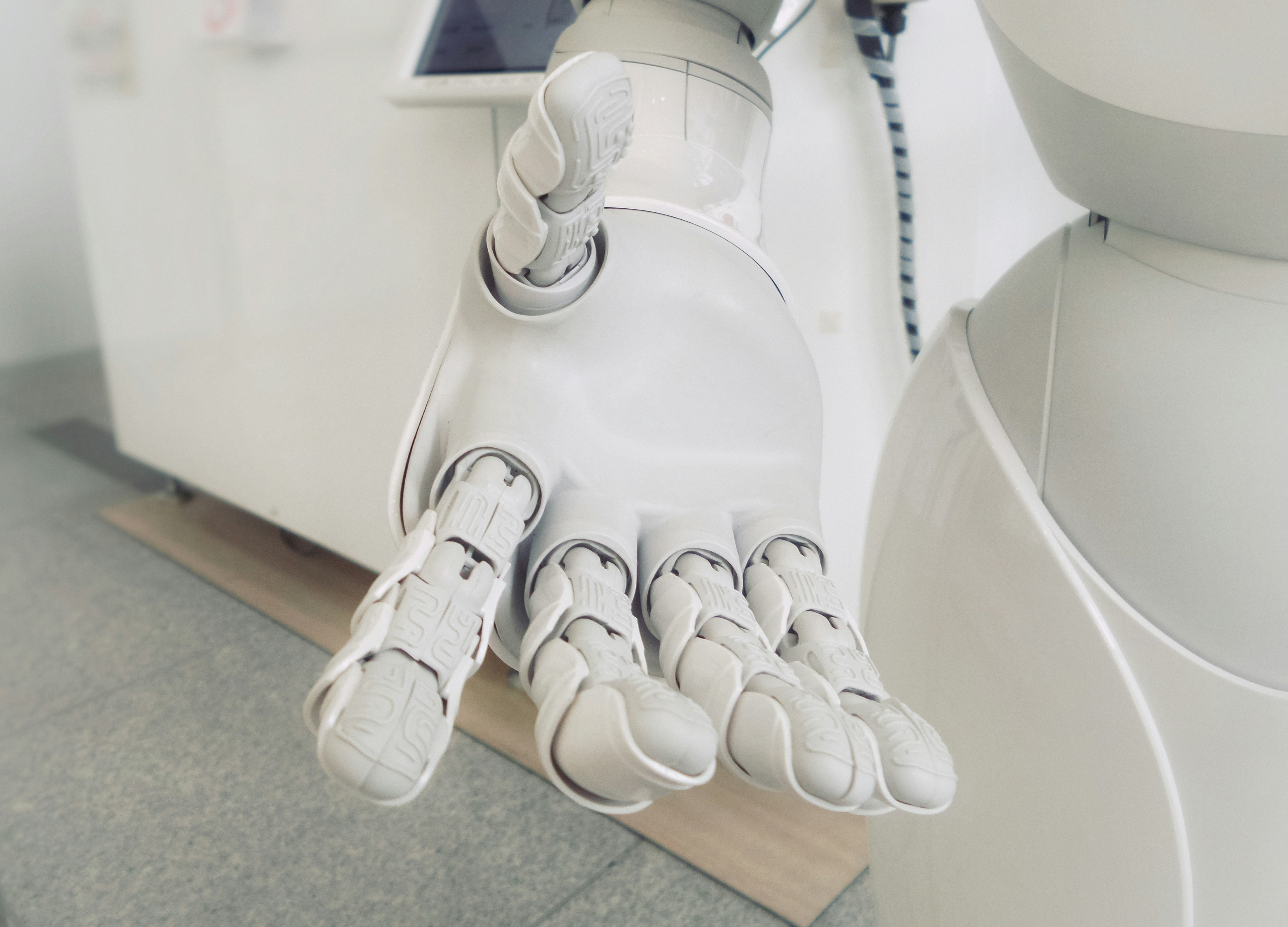 White robot hand reaching out