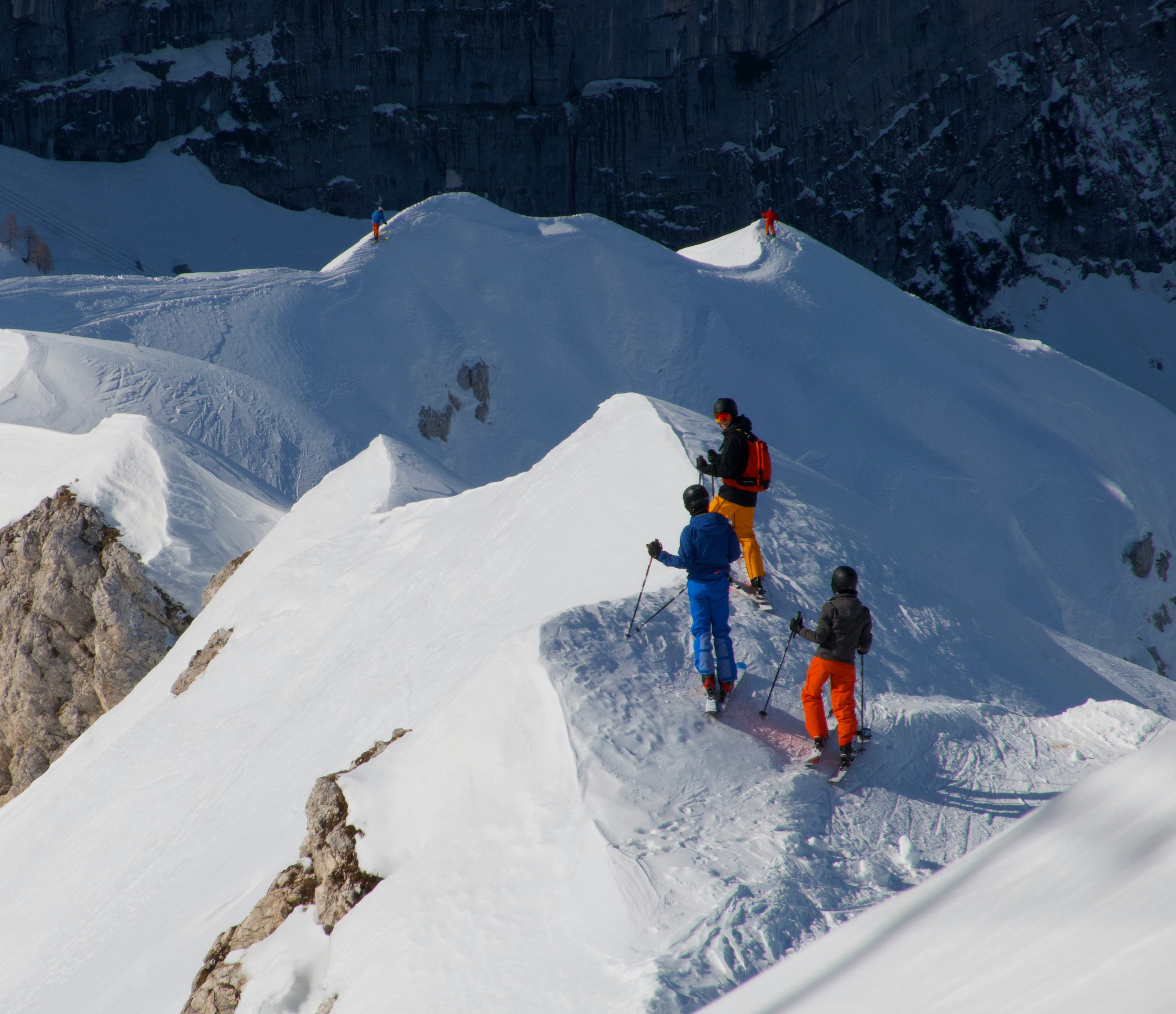 Group of men hiking a snowy mountain.